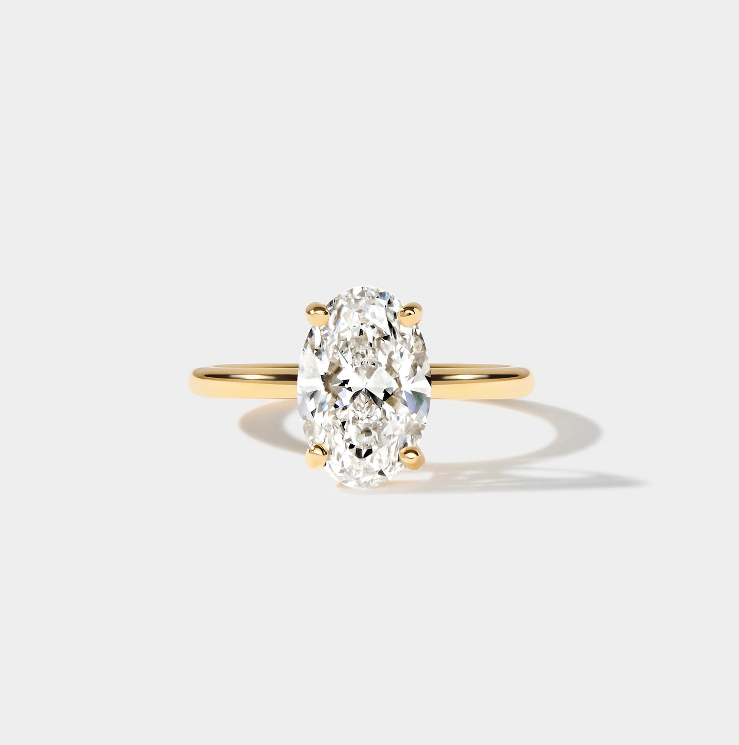 Elongated oval diamond engagement ring in yellow gold, 3 carat lab-grown diamond, custom made in the USA