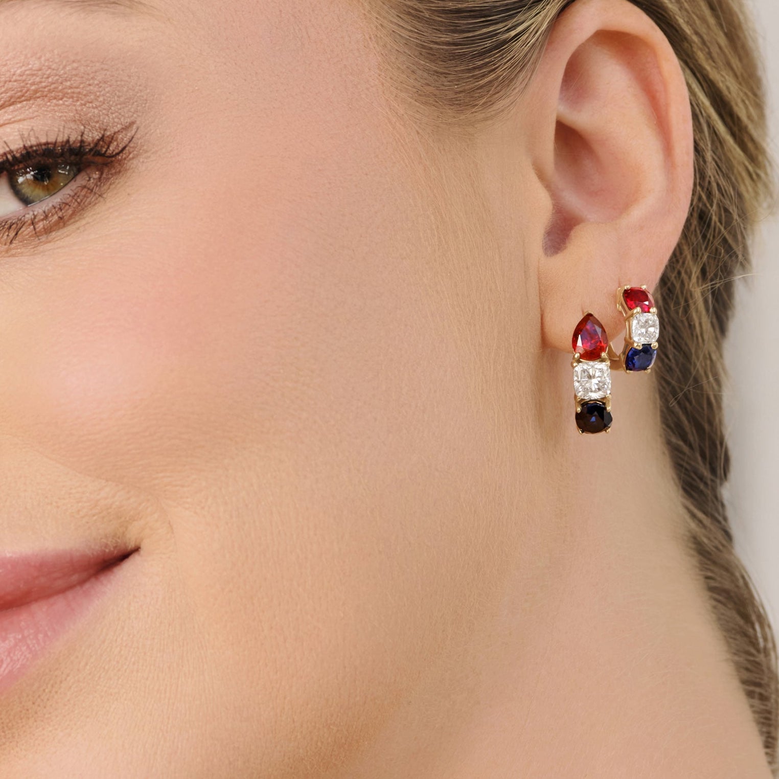 Close-up of America 250 hoop earrings with lab-grown ruby, diamond, and sapphire set in 14k gold, Cove Fine Jewelry