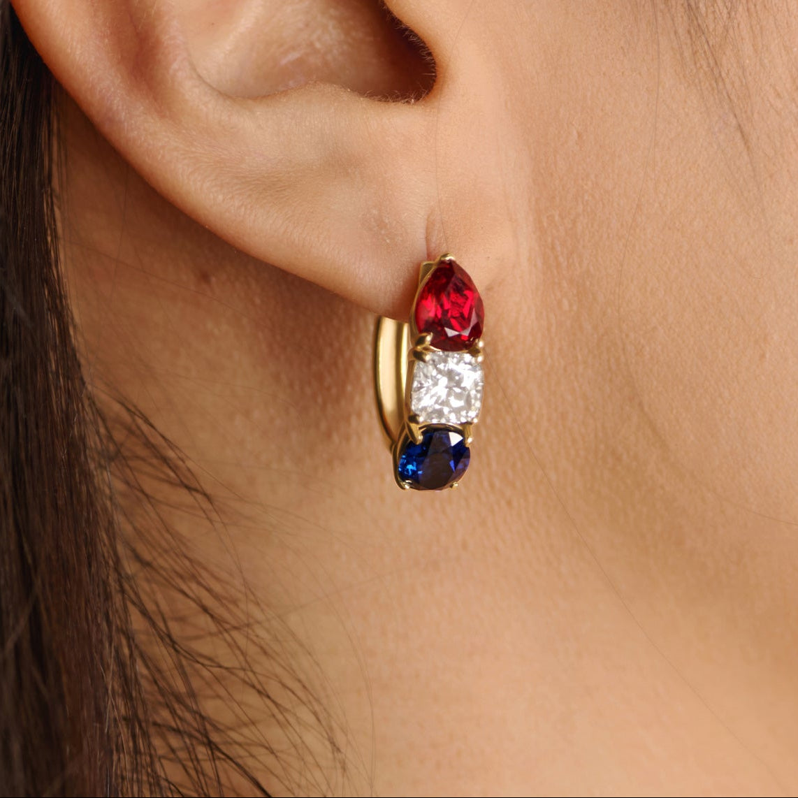 Solid gold America250 earrings with lab-grown diamonds, sapphires, and rubies styled for a modern luxury jewelry campaign.