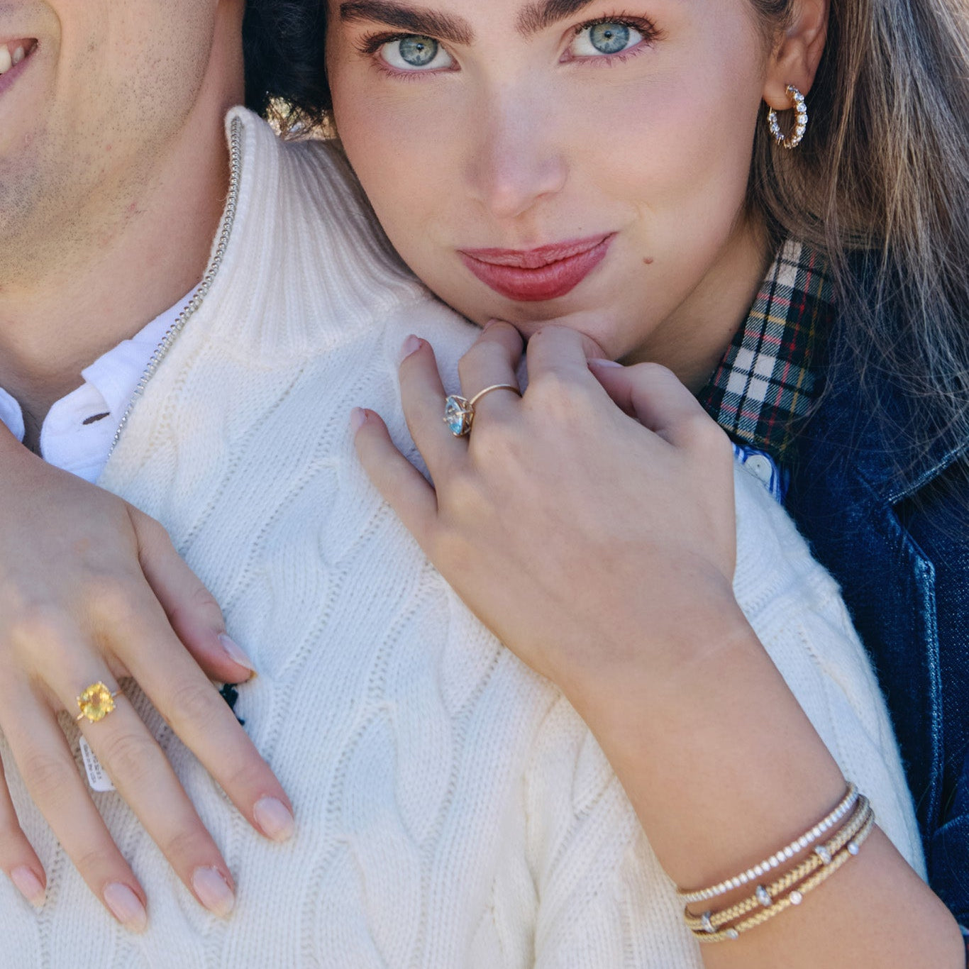 Stacked gold bracelets featuring flexible lab-grown diamond tennis bangle
