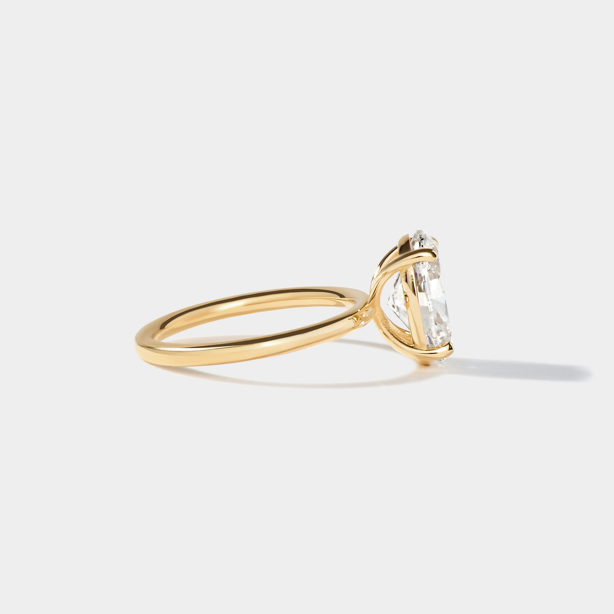 Elongated oval lab-grown diamond solitaire engagement ring with an elegant four-prong setting.