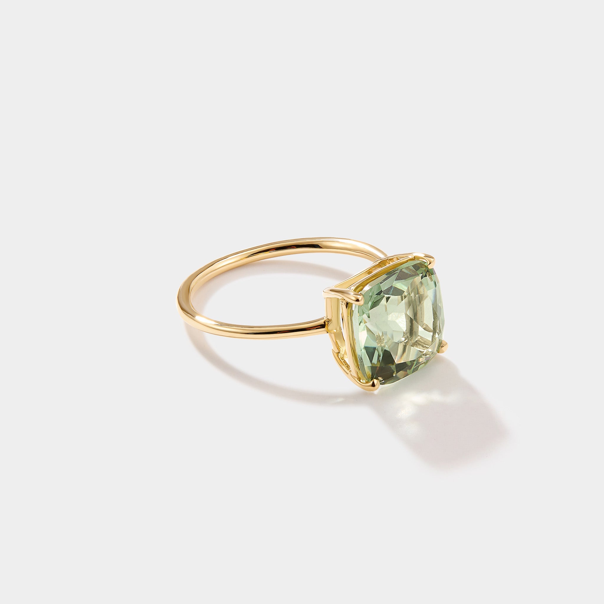 Close-up of cushion cut green amethyst parasolite gemstone set in solid 14k gold statement ring