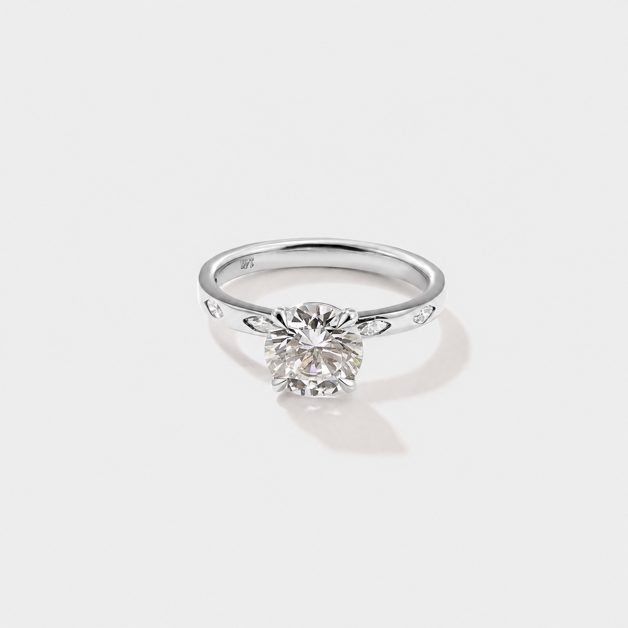 Round lab-grown diamond engagement ring accented with marquise-cut diamonds along the band.