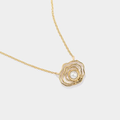 Close-up of our 14K gold oyster pearl necklace featuring a pearl