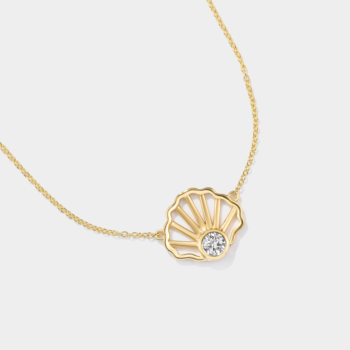14K yellow gold scallop shell necklace with a bezel-set lab-grown diamond, inspired by Cape Cod coastal jewelry.