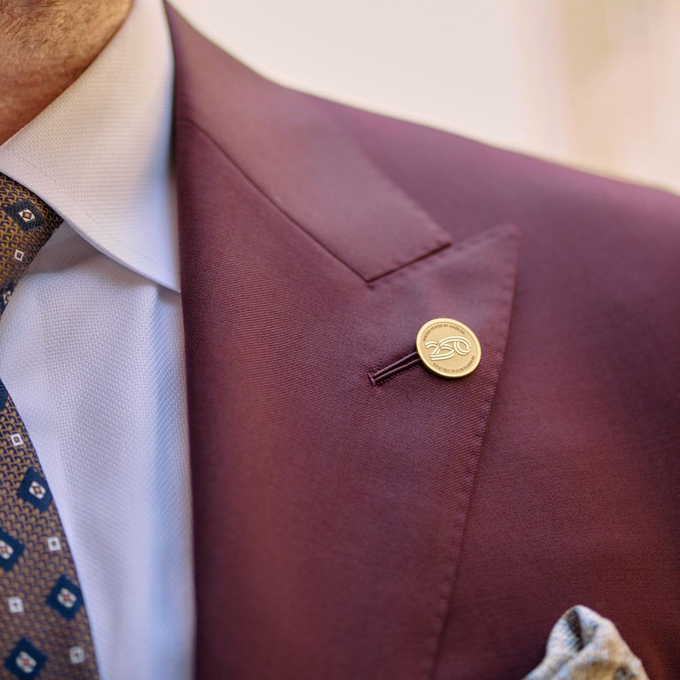 Official America250™ 14K gold commemorative lapel pin with signature anniversary logo, designed to celebrate America&