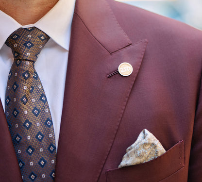 Man wearing a 14k Gold America250 Lapel Pin Commemorative. 