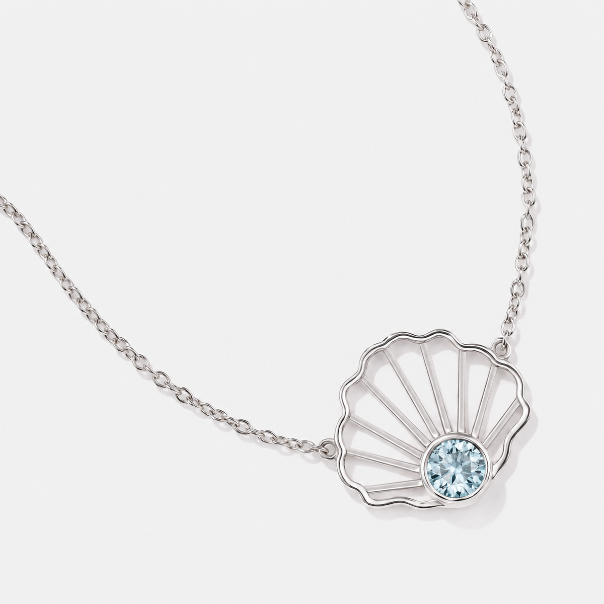 14k gold scallop shell necklace with bezel-set natural aquamarine, inspired by shells found along the beach.
