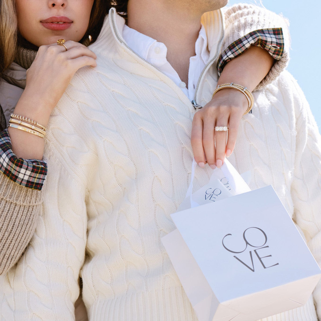 photo of a man and woman with a gift bag to a fine jewelry store with a gift card.