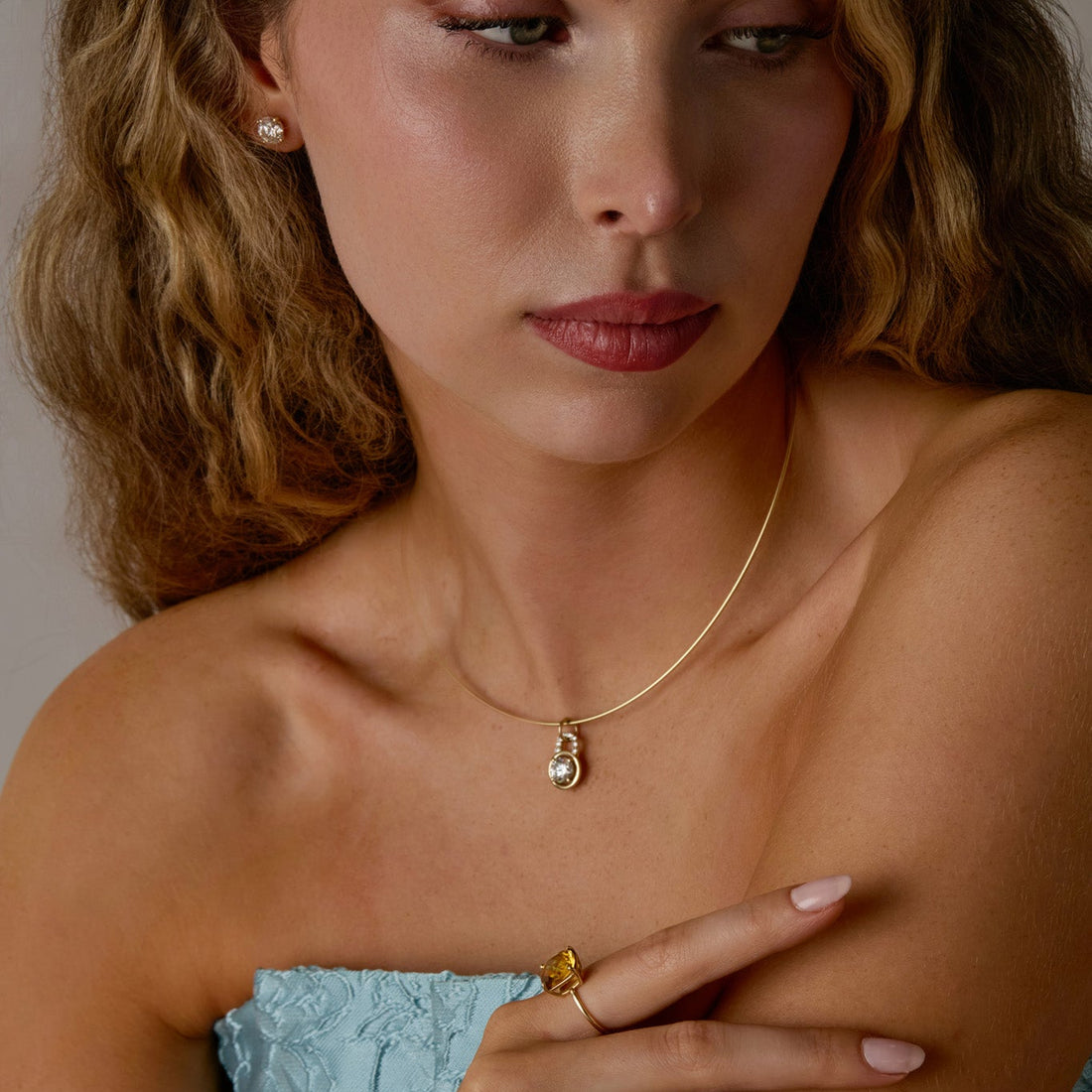 Woman wearing a diamond locket pendant on omega chain