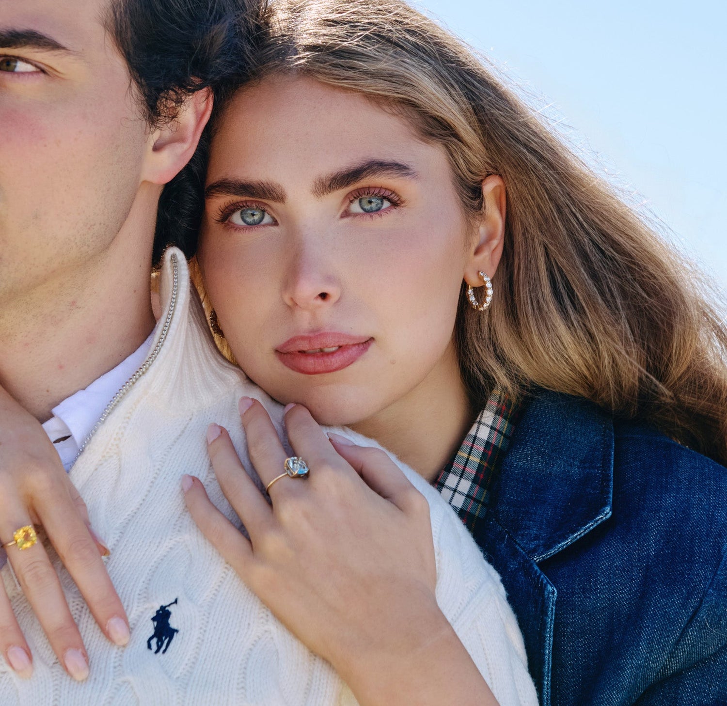 Woman wearing large lab grown diamond hoops.