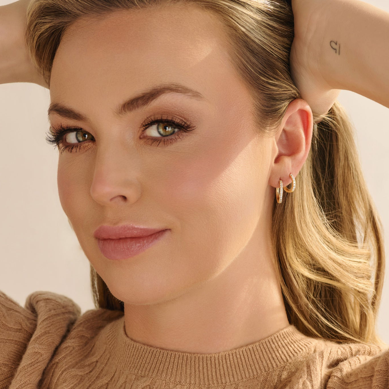 woman wearing lab grown diamond earrings