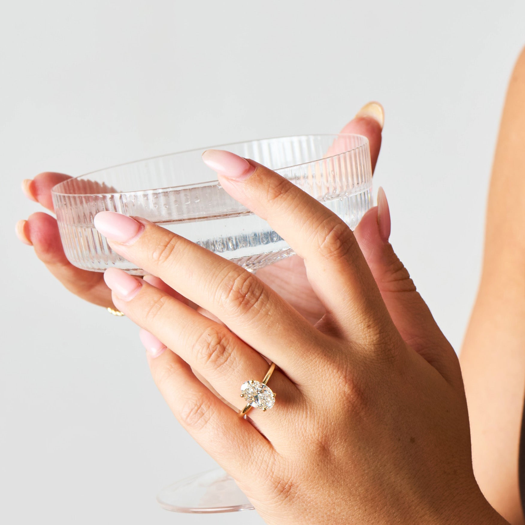 A woman wearing a lab grown oval diamond ring. 
