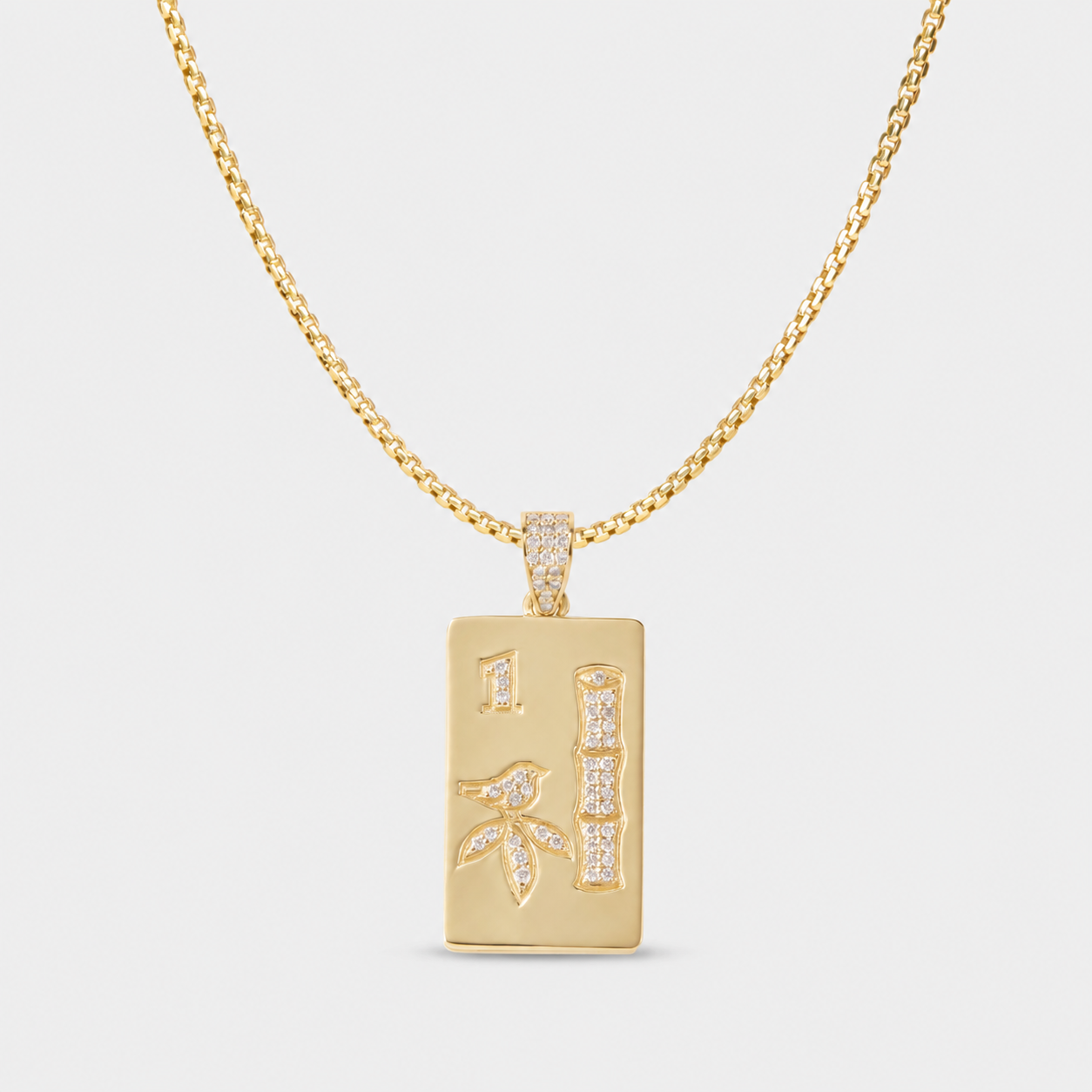 Luxury mahjong necklace in solid 14k gold with diamond details and colorful gemstone accents