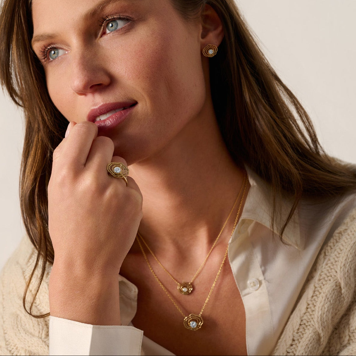Bayside Mini Oyster Diamond Necklace layered with another gold necklace on a model