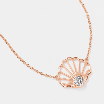 Close up details of rose 14k gold seashell diamond necklace