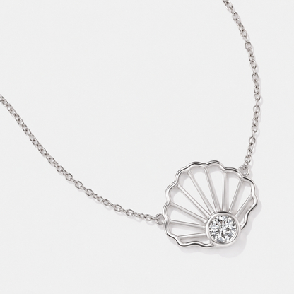 Close up details of white 14k gold seashell diamond necklace