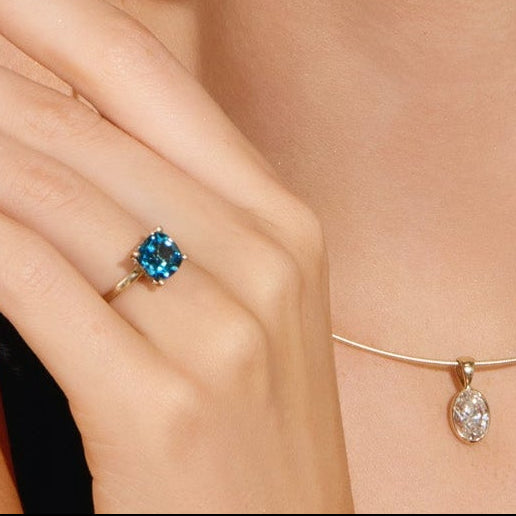 Model wearing blue topaz and green diamond ring inspired by Cape Cod hydrangeas and coastal style