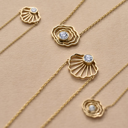 Inspired by the beaches, tidal flats, and coastal traditions of Cape Cod, our collection of solid 14K gold jewelry offers a fresh interpretation of classic Cape Cod style. Discover scallop shell pendants, oyster charms, and fine gold jewelry designed with a sense of place.