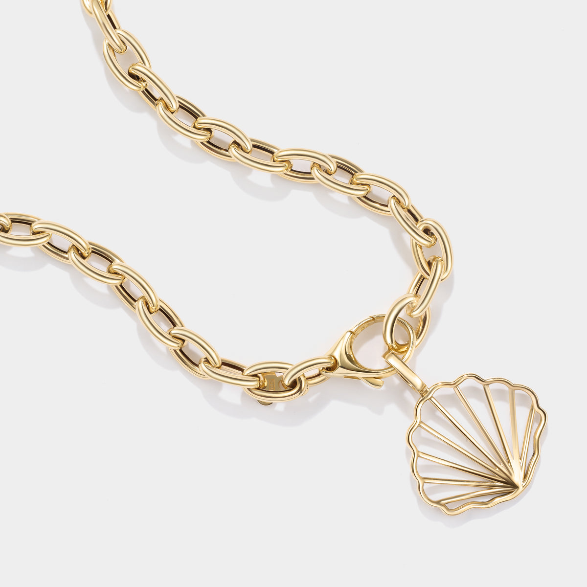Solid 14K gold scallop shell charm inspired by the beaches and tidal flats of Cape Cod