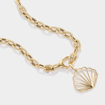 Solid 14K gold scallop shell charm inspired by the beaches and tidal flats of Cape Cod