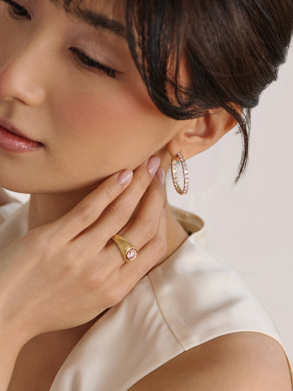 Woman wearing pink diamond ring styled with coastal light and soft beach inspired tones