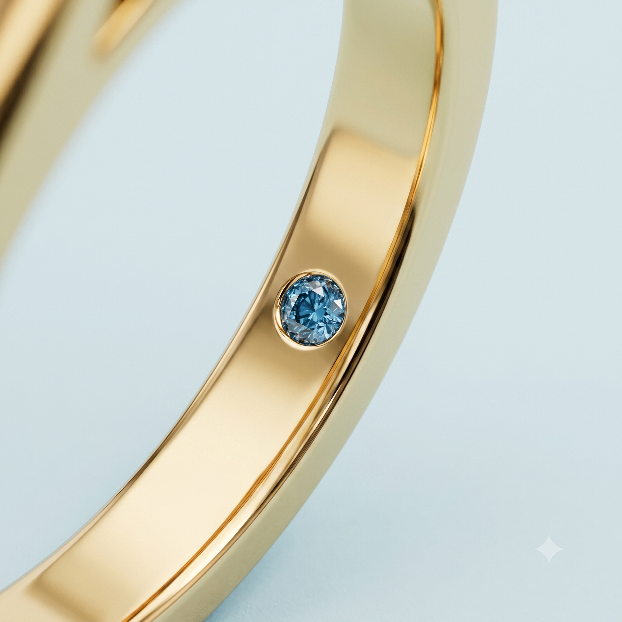 Close-up of Cove’s signature ocean-blue diamond flush-set inside a polished yellow-gold engagement ring band.