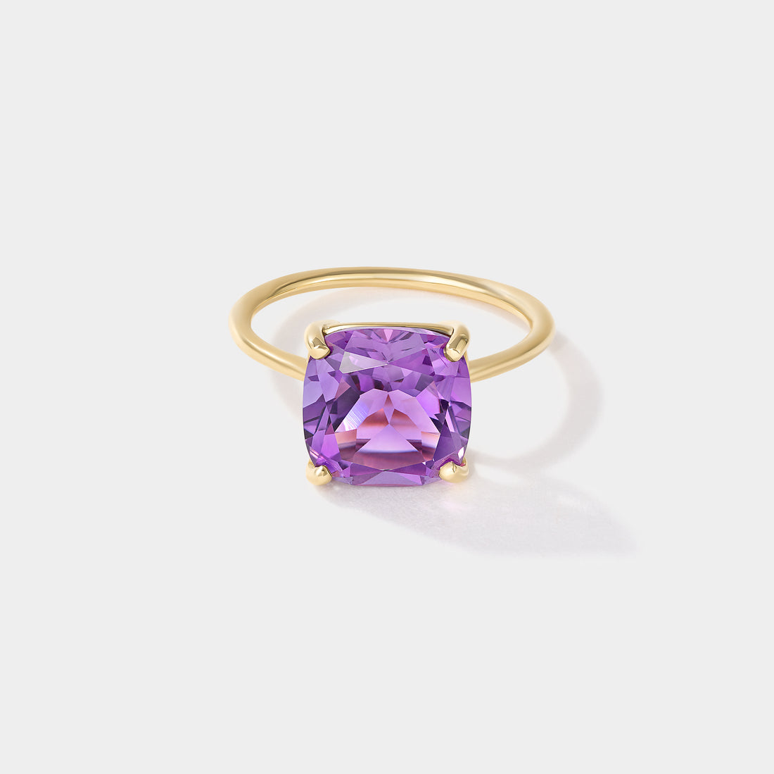 Purple cushion-cut amethyst solitaire ring in solid 14k yellow gold with four-prong setting, Drift by Cove Fine Jewelry.