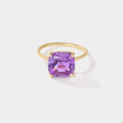 Purple cushion-cut amethyst solitaire ring in solid 14k yellow gold with four-prong setting, Drift by Cove Fine Jewelry.