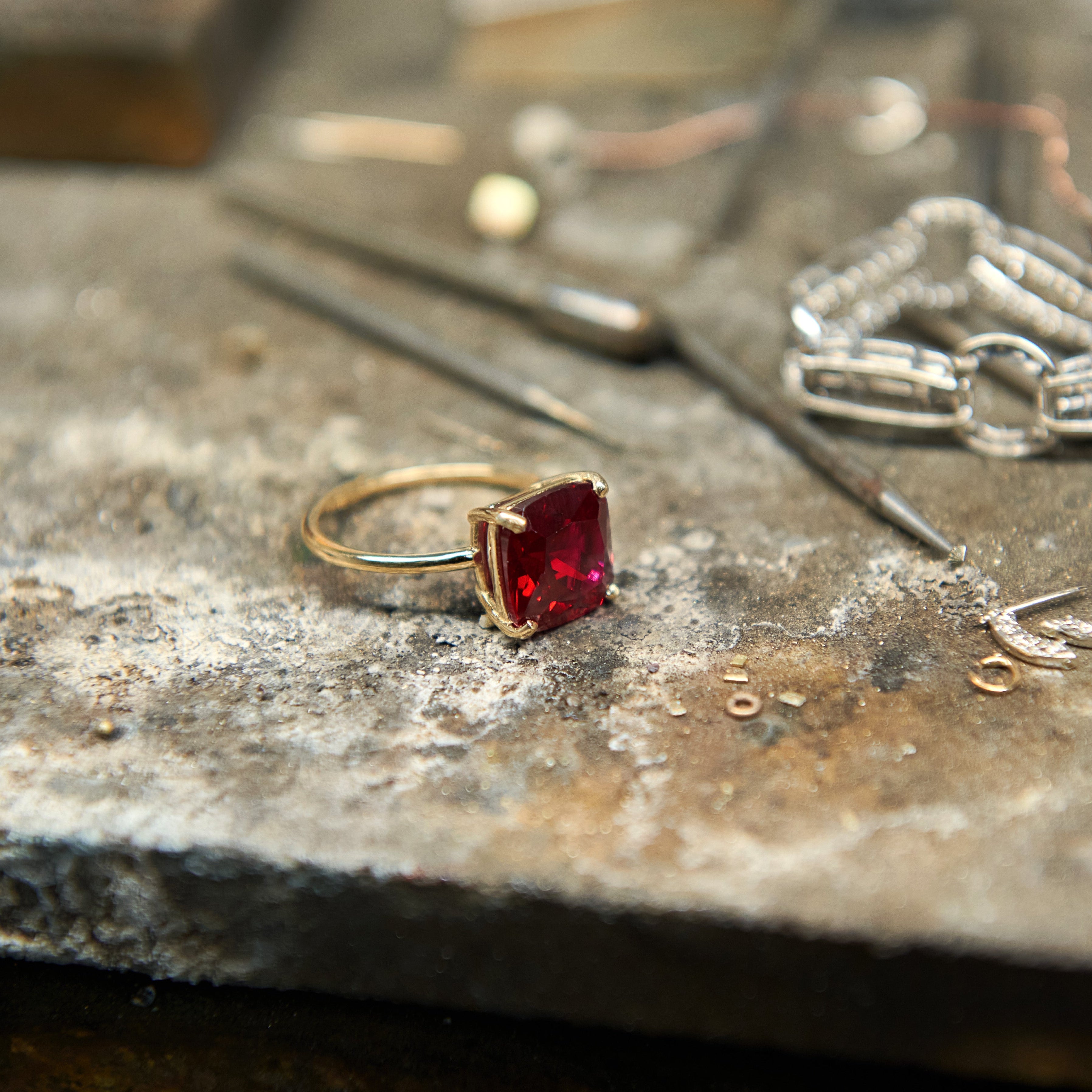 Cushion cut ruby statement ring with 10 mm lab grown ruby gemstone set in polished 14k gold.