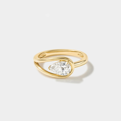 East-west pear-shaped lab-grown diamond ring in 14K yellow gold with a modern wrap setting.