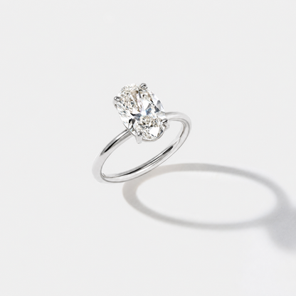 Elongated oval solitaire diamond engagement ring in polished white gold, shown from the front.