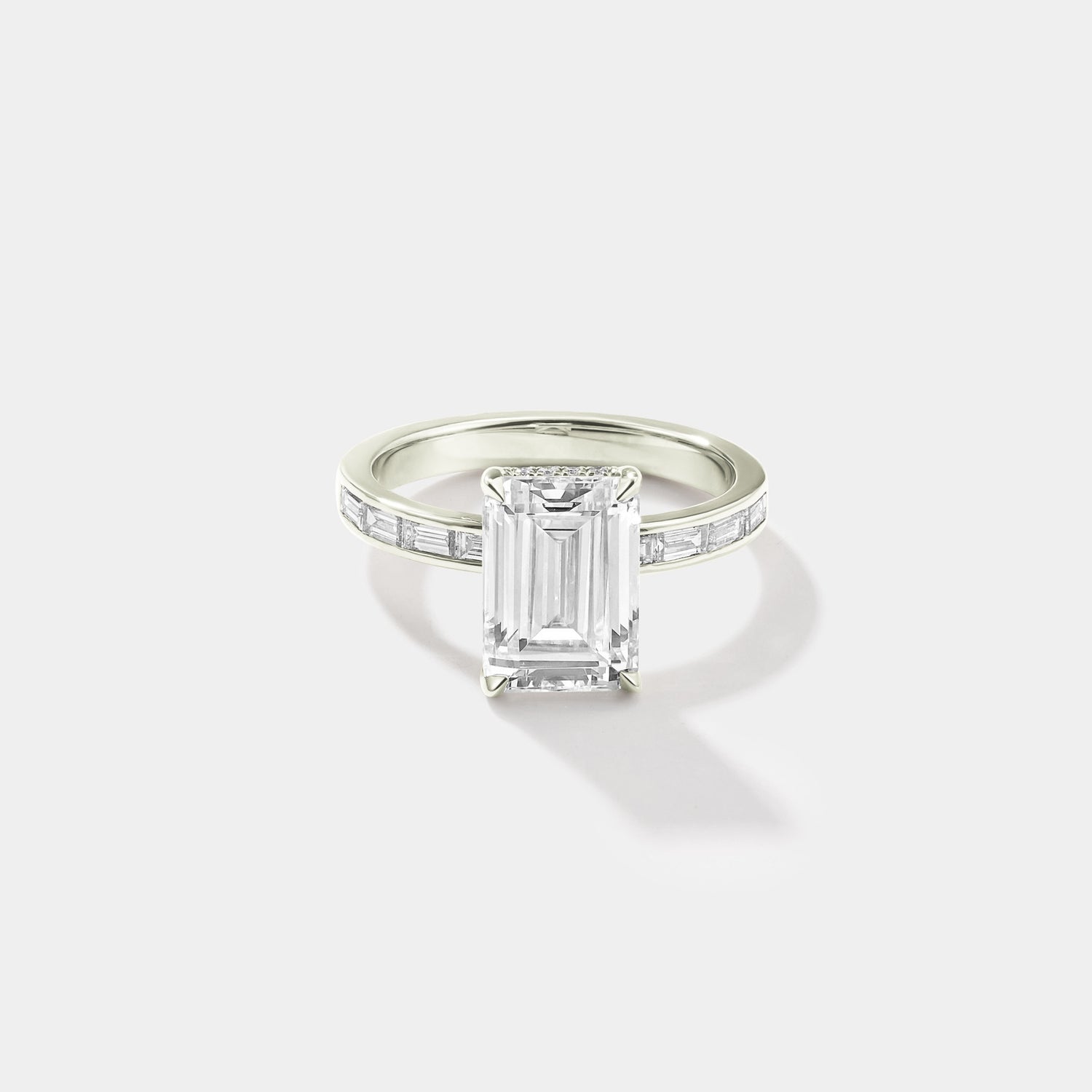 Emerald-cut lab-grown diamond engagement ring with a hidden halo and channel-set band in white gold