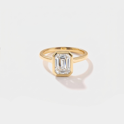 Emerald cut bezel solitaire lab-grown diamond engagement ring in 14K yellow gold by Cove Fine Jewelry