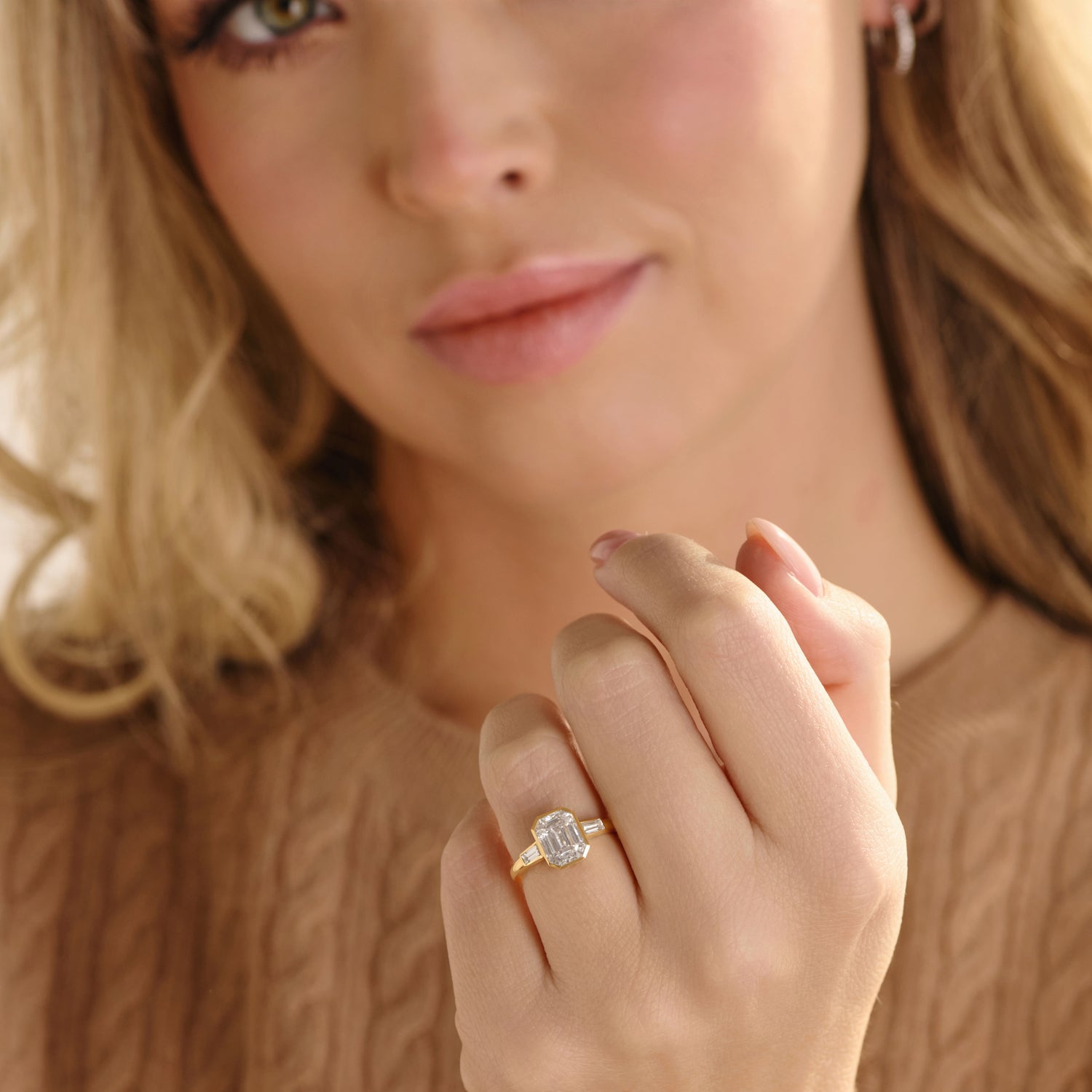 A bezel set emerald cut ring with bezel side diamonds. 