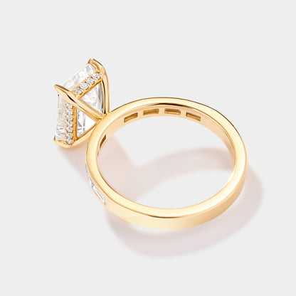 Profile of an emerald-cut diamond engagement ring showing the delicate hidden halo under the prong-set center