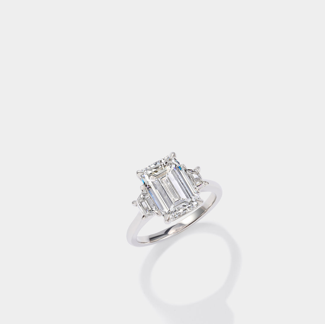 Emerald cut three stone lab-grown diamond engagement ring in 14K yellow gold by Cove Fine Jewelry