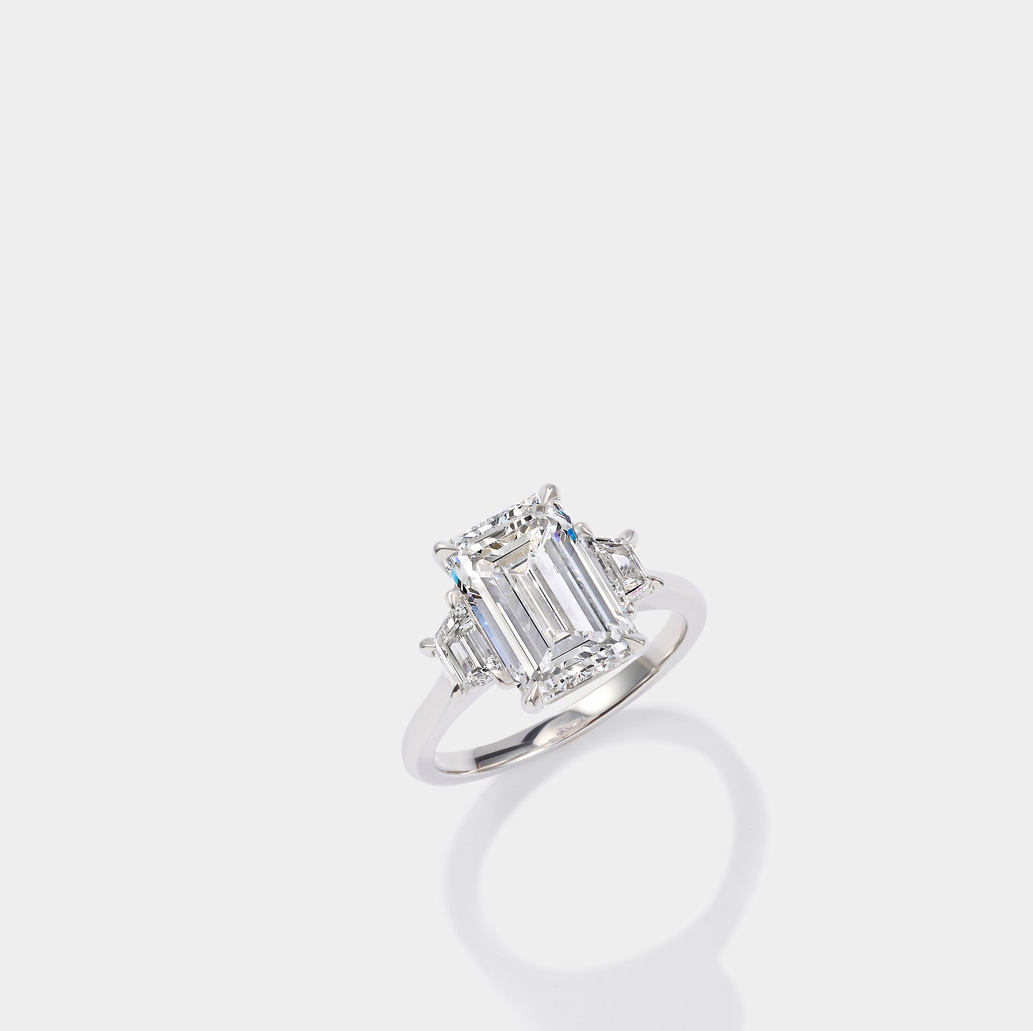 Emerald cut three stone lab-grown diamond engagement ring in 14K yellow gold by Cove Fine Jewelry
