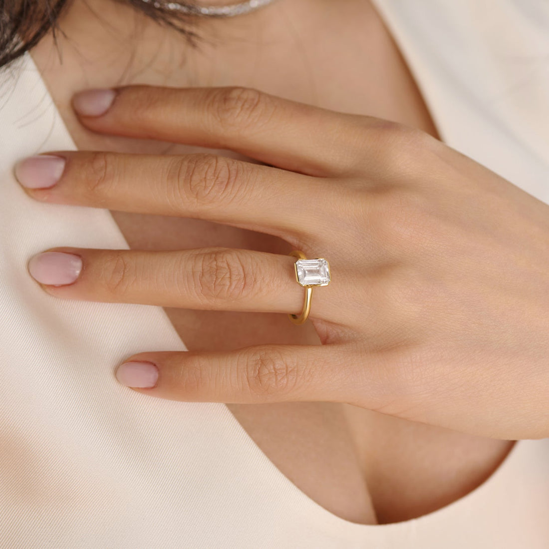 Close-up of emerald cut half bezel solitaire lab-grown diamond engagement ring setting