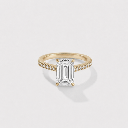 Emerald-cut lab-grown diamond engagement ring with a hidden halo and cathedral pavé band in yellow gold