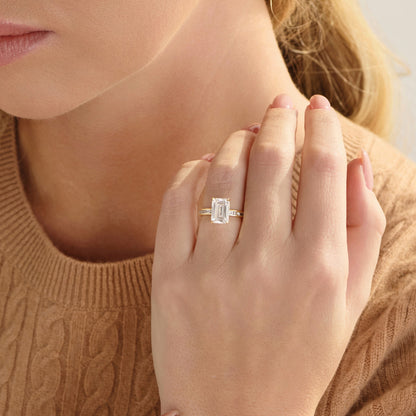 Hidden halo sparkling beneath the emerald-cut center diamond of a lab-grown engagement ring
