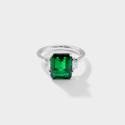 white gold lab grown emerald three stone ring with emerald cut emerald and trapezoid diamonds