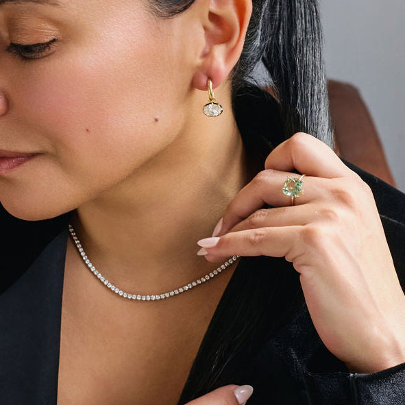 Large green amethyst cushion cut ring in 14k gold worn on model hand showing mint green gemstone statement ring