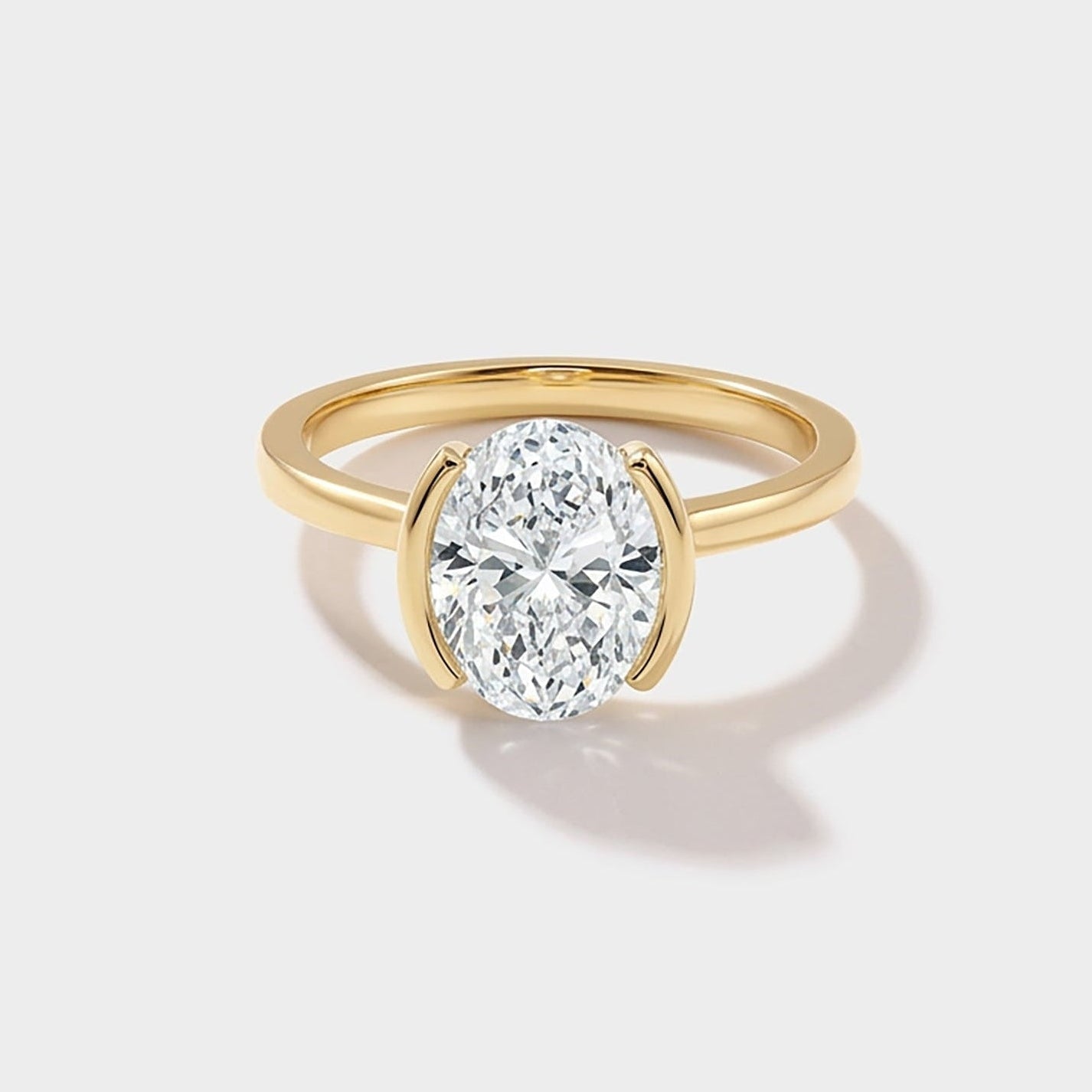 Oval bezel band solitaire lab-grown diamond engagement ring in 14K gold by Cove Fine Jewelry