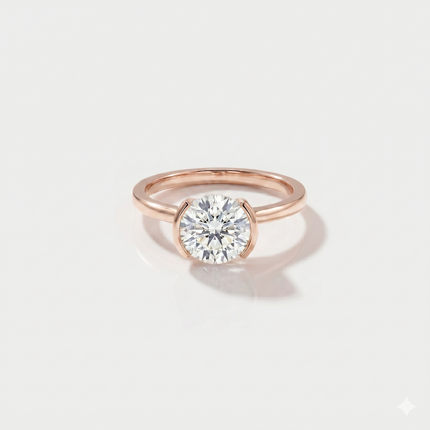 Round half bezel solitaire lab-grown diamond engagement ring in 14K rose gold. 
