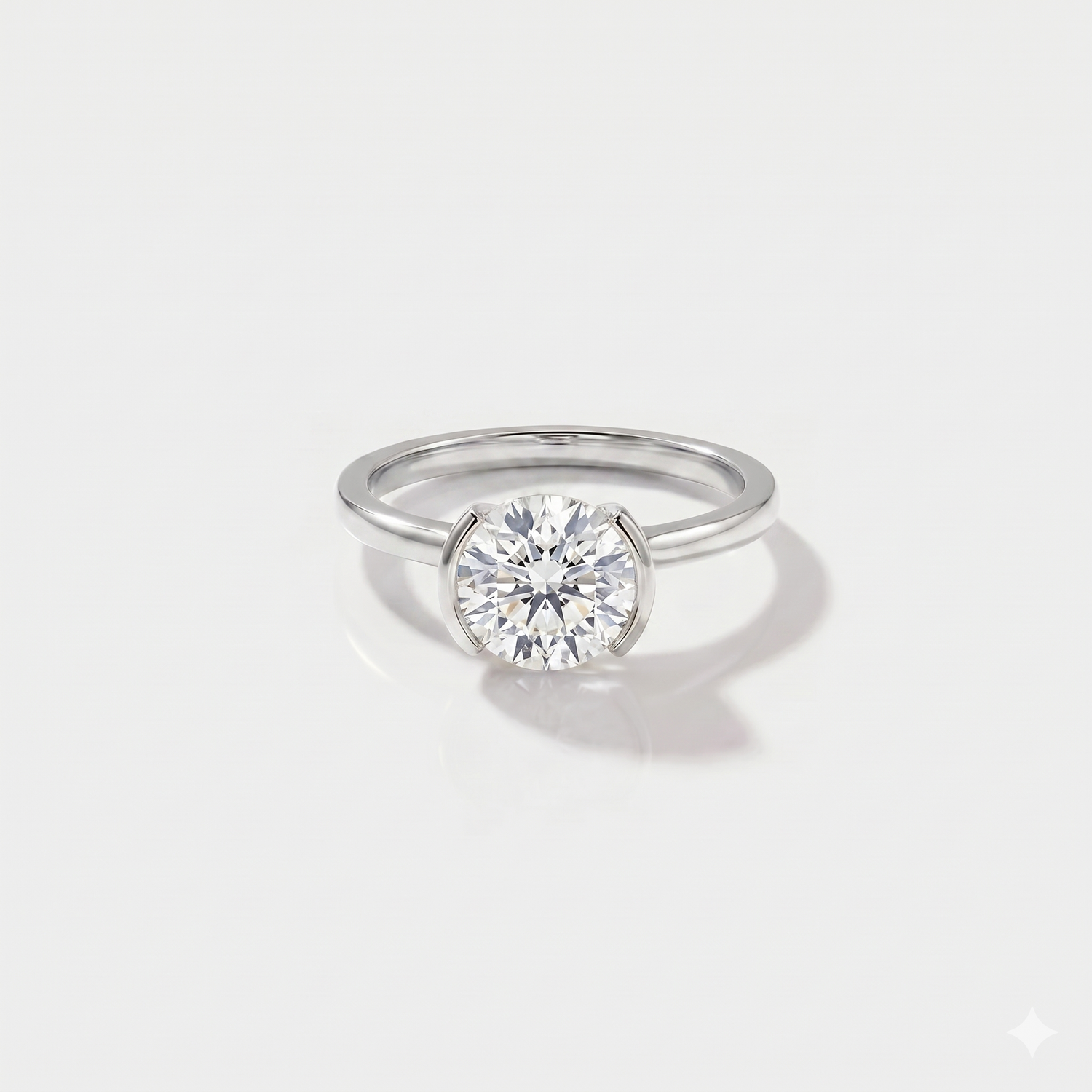 Round half bezel solitaire lab-grown diamond engagement ring in 14K white gold. 
