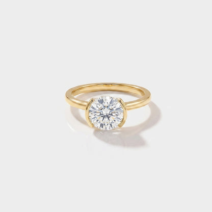 Round half bezel solitaire lab-grown diamond engagement ring in 14K gold by Cove Fine Jewelry