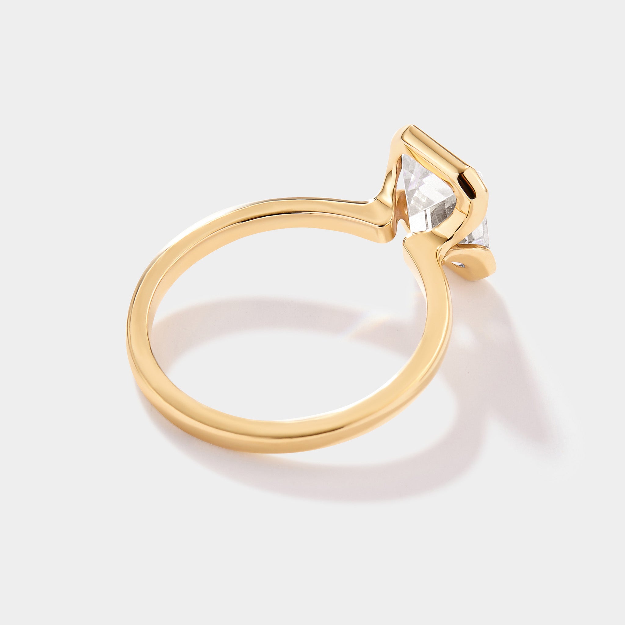 Custom emerald-cut lab-grown diamond engagement ring in a refined half-bezel solitaire design.