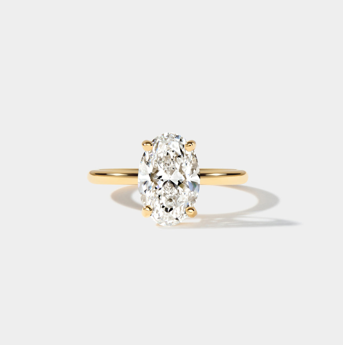 Lab-grown elongated oval diamond engagement ring with a classic solitaire setting and slender band.