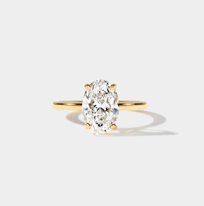 Lab-grown elongated oval diamond engagement ring with a classic solitaire setting and slender band.